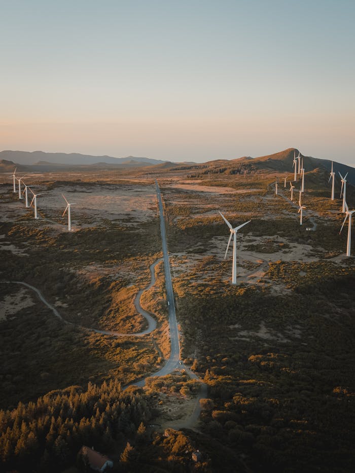 Aerial view of wind turbines in Sao Vicente, Madeira, Portugal, capturing renewable energy in the scenic landscape at sunset.